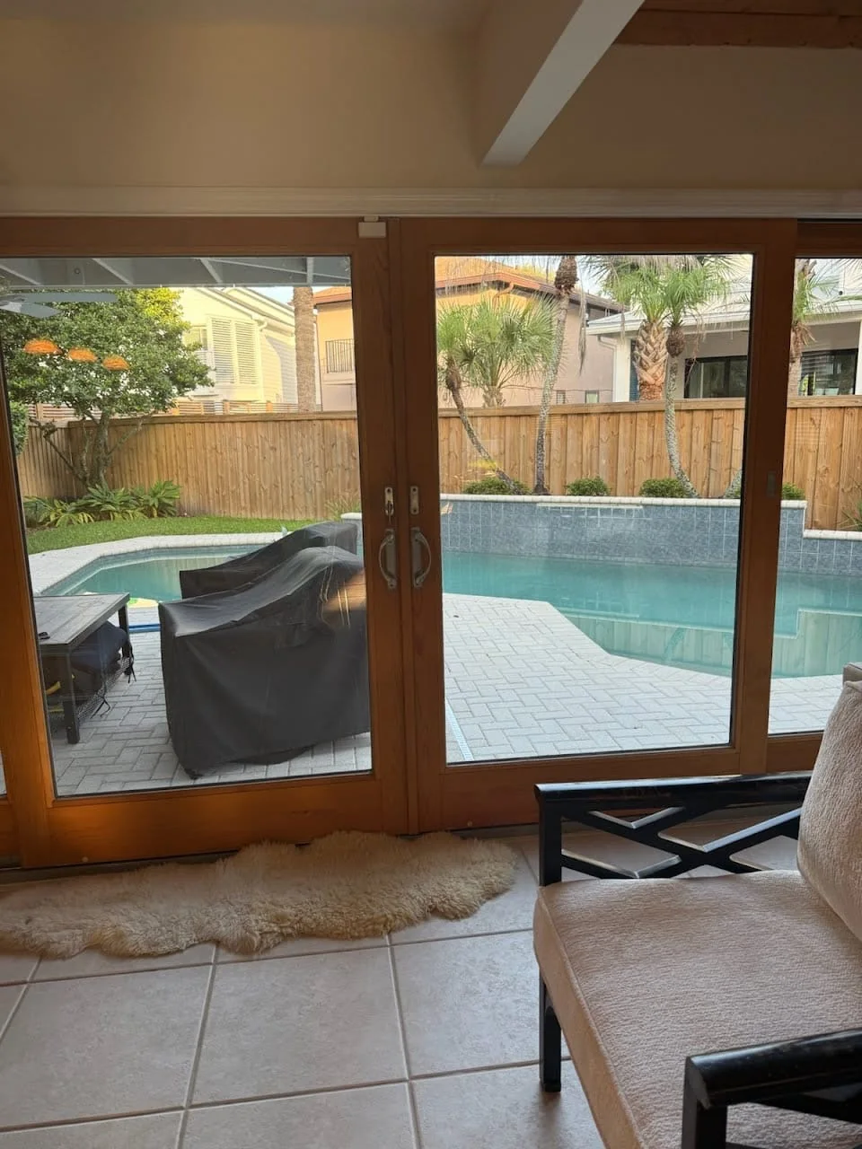 Sliding patio door overlooking a pool and screened lanai