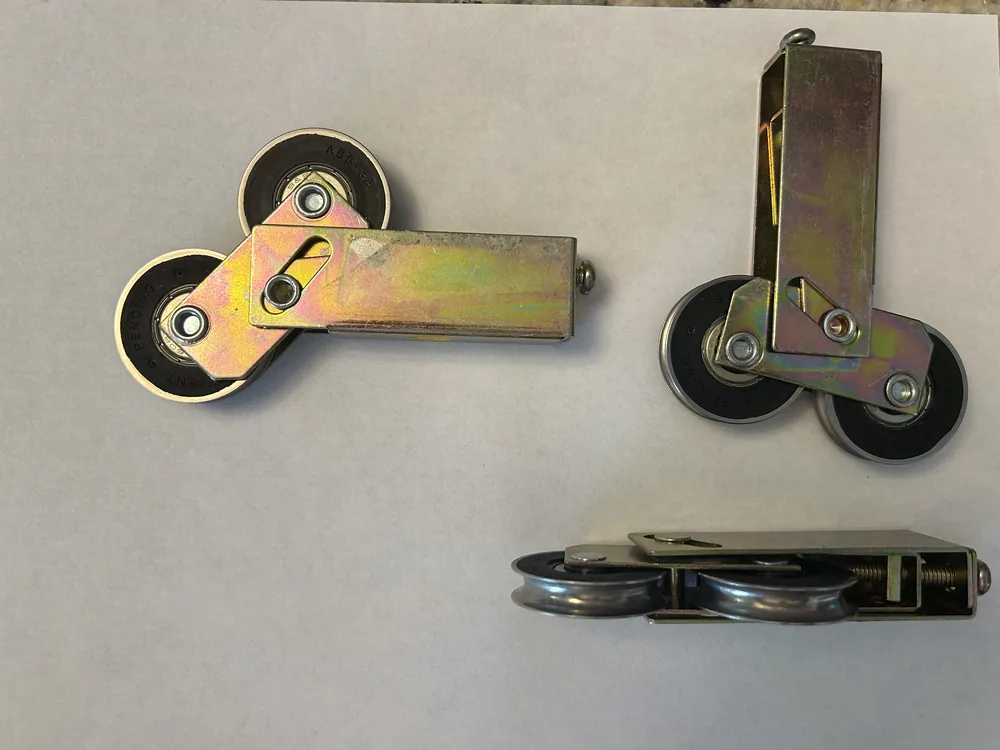 Several sliding door roller assemblies laid out