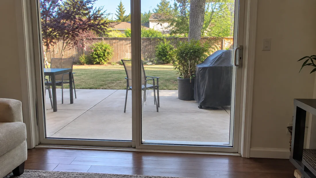 Sliding glass door opening onto a Florida backyard