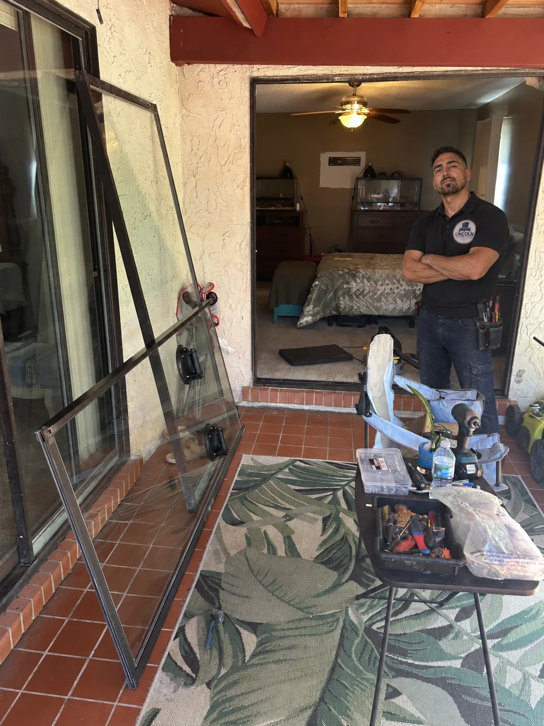 Lincoln Sliding Doors technician on site with removed sliding door glass panels