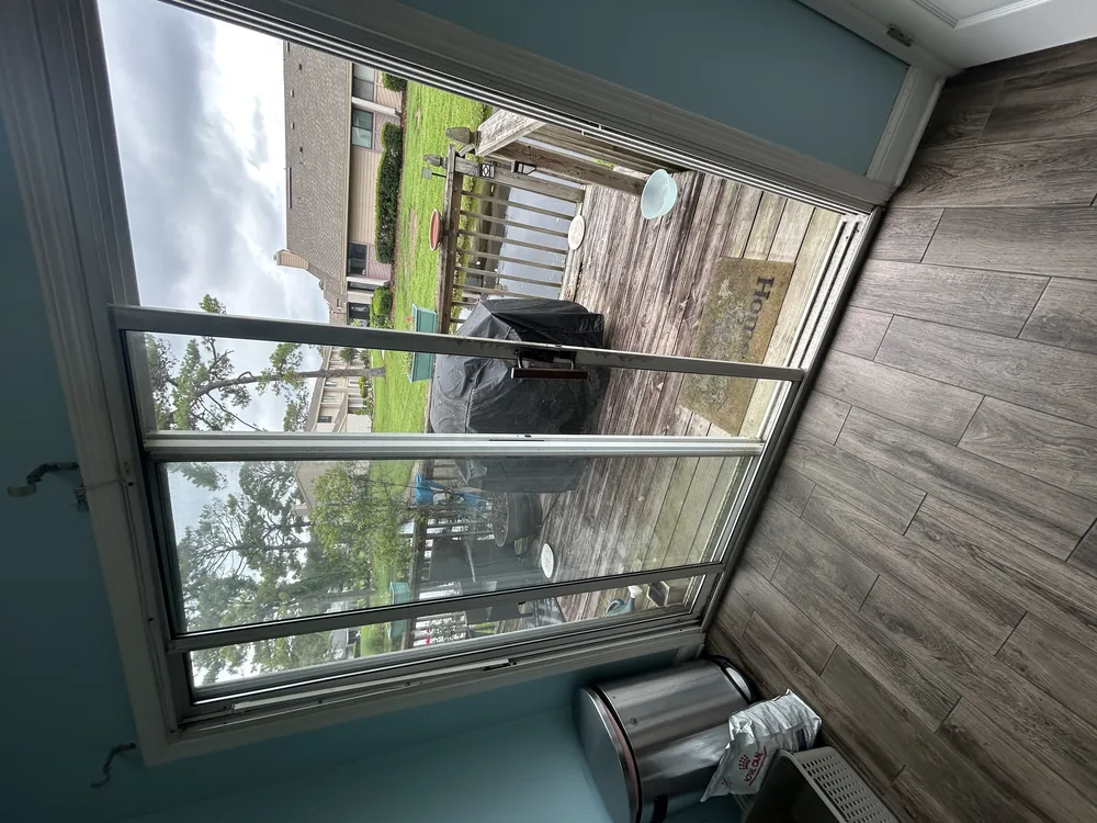 Sliding door track and sill being cleaned and inspected